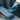 Gloved hand reaching over a tray of surgical instruments